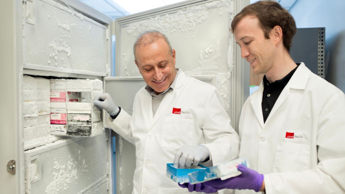 Dr. Rakez Kayed (left) removes specimens from a freezer